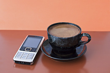 Image showing cup of coffee and mobile phone