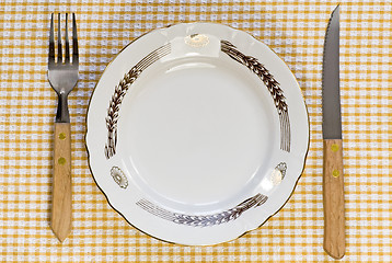 Image showing plate with fork and knife on tablecloth