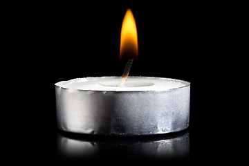 Image showing burning candle in darkness 