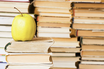Image showing yellow apple on stack of books