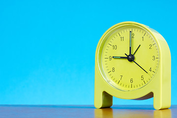Image showing alarm clock  against blue background