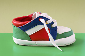 Image showing baby shoeon green background