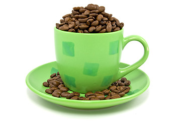 Image showing cup with coffee beans over a white background