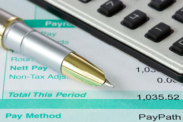 Image showing pen,calculator and payslip