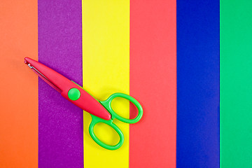 Image showing Colorful paper with child's scissors 
