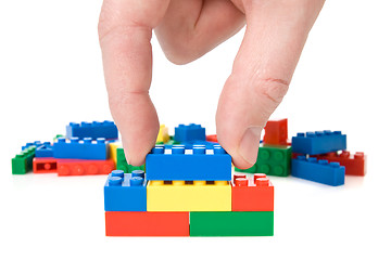 Image showing Hand and toy blocks