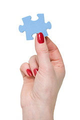 Image showing hand with a piece of blue puzzle