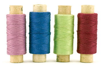 Image showing four colorful thread spools