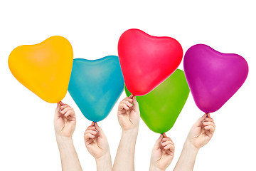 Image showing Hands hold color balloons in the shape of heart
