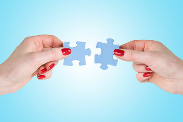 Image showing hands  connecting puzzle pieces