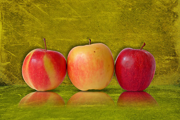 Image showing three apples on green background