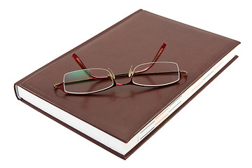 Image showing eyeglasses and book