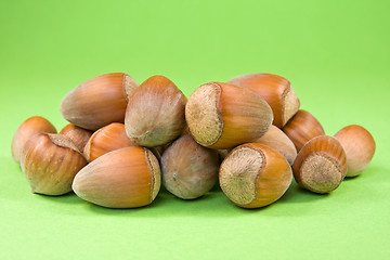 Image showing hazelnuts on the green background