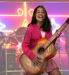 Image showing Happy teen girl with guitar