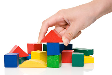 Image showing hand make a building of colored blocks