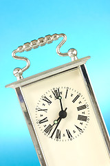 Image showing clock  over a blue background