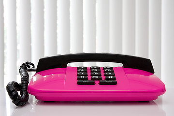 Image showing pink office telephone