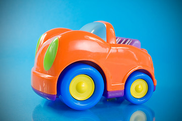 Image showing orange car toy over a blue 