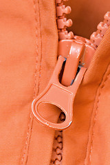 Image showing zipper of a orange jacket
