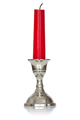 Image showing Silver plated candlestick  with red candle 