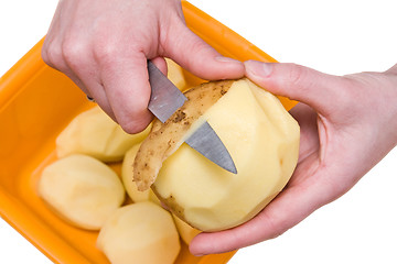 Image showing hands peeling potatoes