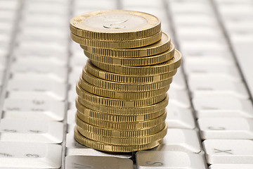 Image showing  stack of coins on computer keyboard