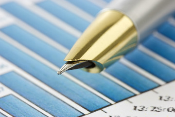 Image showing pen on financial  graphs