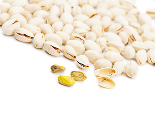 Image showing dry salted pistachios on white background