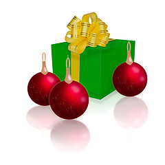 Image showing green gift box with gold ribbon and bow and Christmas balls isol