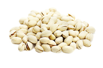 Image showing dry salted pistachios on white background