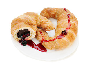 Image showing croissant with chocolate and raspberry jam on plate isolated on 