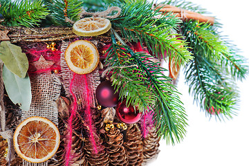 Image showing Christmas-tree branch decorated with balls, beads, cinnamon and 