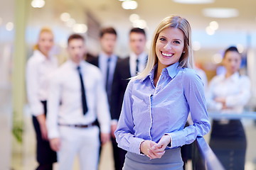 Image showing business woman with her staff in background at office