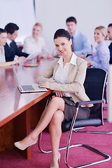 Image showing business woman with her staff in background at office