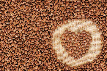 Image showing heart coffee frame made of coffee beans on burlap texture 