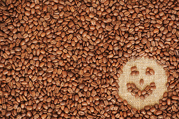 Image showing face coffee frame made of coffee beans on burlap texture 