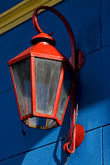 Image showing  red street lamp  and a blue yellow 