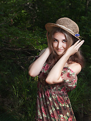 Image showing Beautiful girl in the national dress and hat stand in the  fores