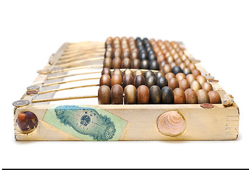 Image showing abstract composition from the old wooden abacus, coins and shell