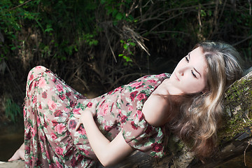 Image showing Beautiful girl in the national dress stand in the river in the  