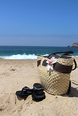 Image showing Seacoast and straw beach bag