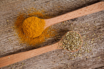 Image showing two spices in wooden spoons 