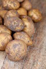 Image showing potatoes on a wooden background