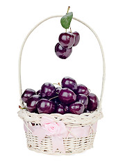 Image showing sweet cherry in a wicker gift basket isolated on white backgroun