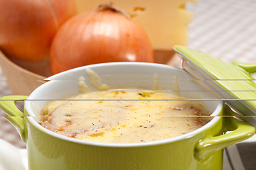 Image showing oinion soup with melted cheese and bread on top