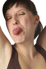 Image showing young woman shows her tongue