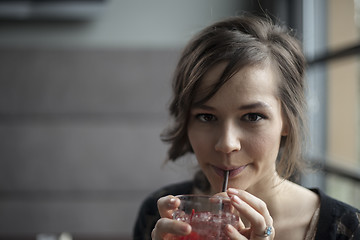 Image showing Young Woman Drinking a Shirley Temple