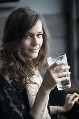 Image showing Young Woman Drinking a Pint Glass of Ice Water