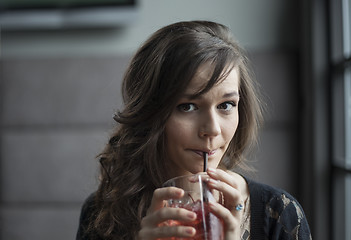 Image showing Young Woman Drinking a Shirley Temple