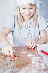 Image showing Young girl pointing to gingerbread shape